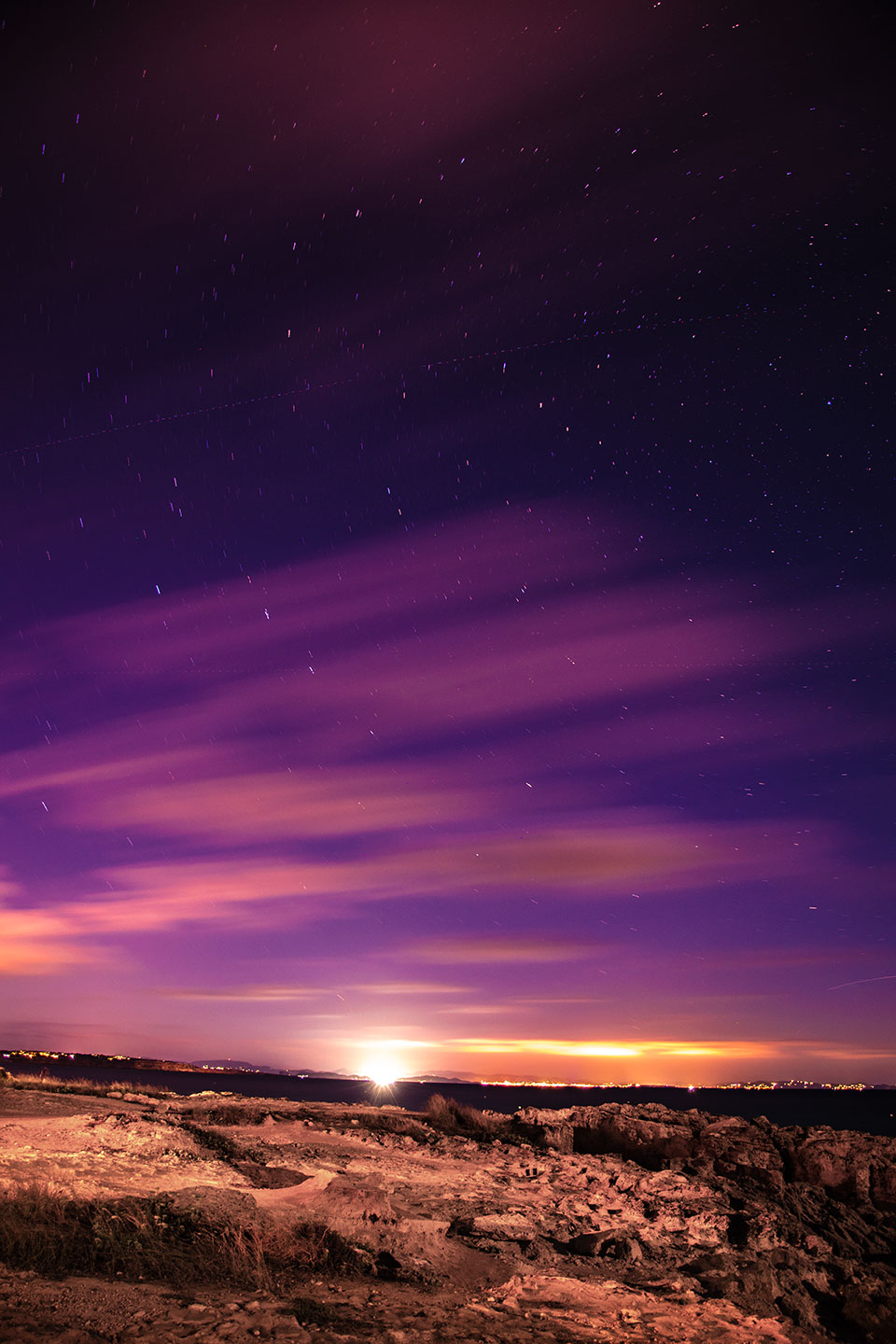 Slow speed shutter night photography with stars movment in the sky above Ibiza from Es Calo, Formentera, Spain, (Nos Dren).