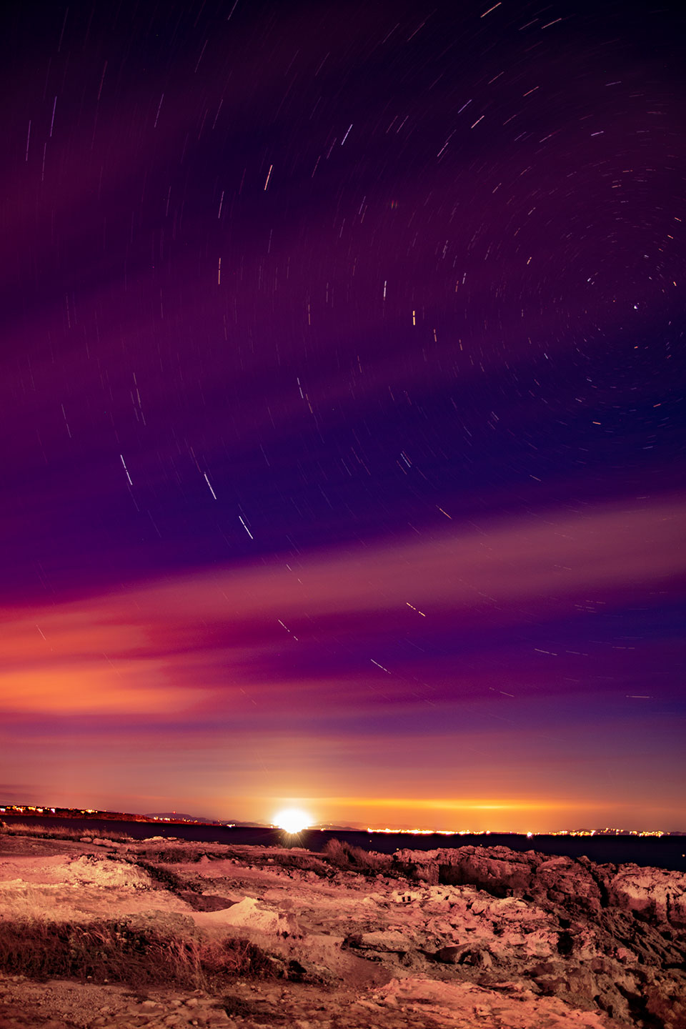 Very slow speed shutter night photography with stars movment in the sky above Ibiza from Es Calo, Formentera, (Nos Dren).