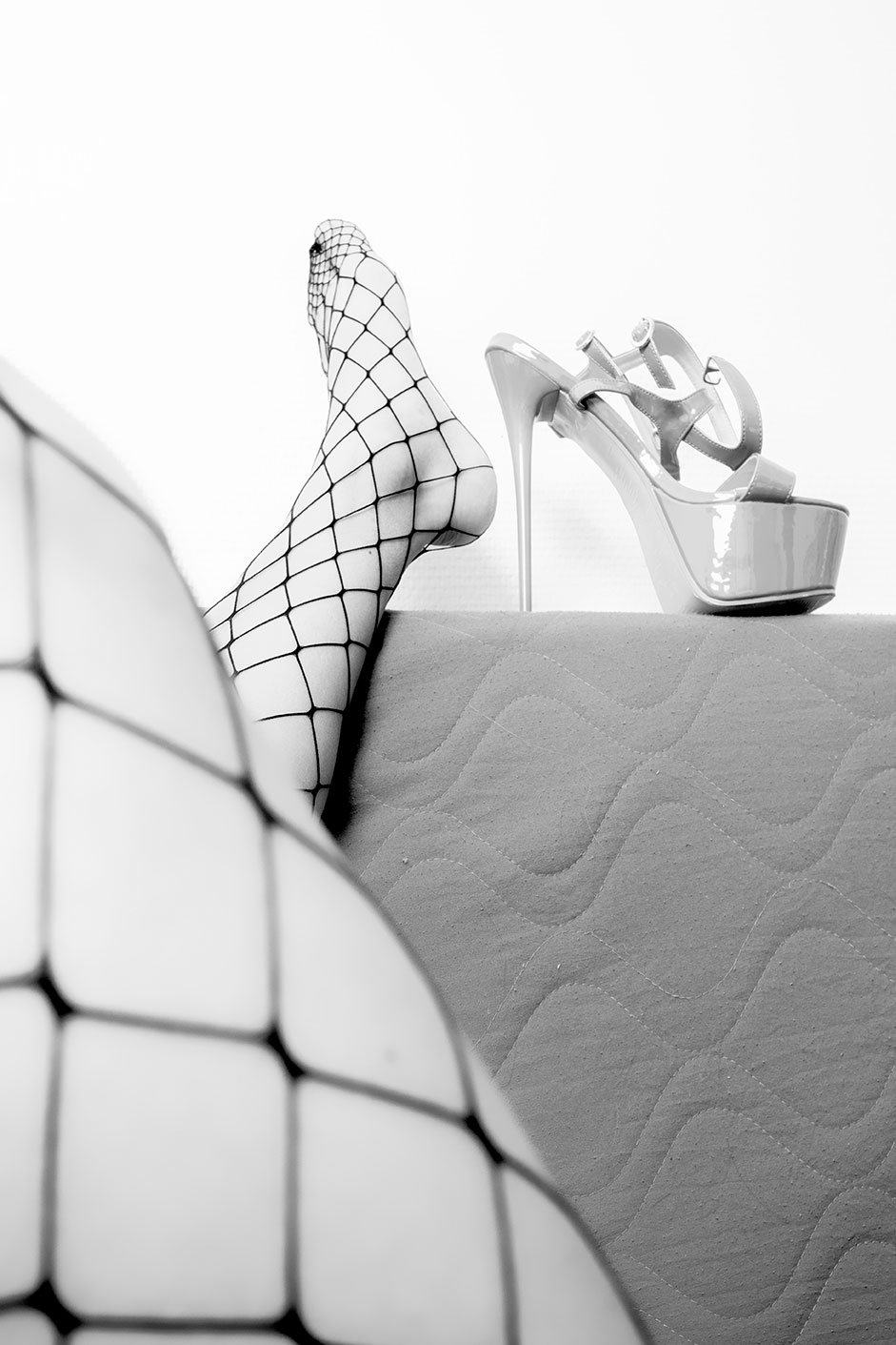 Black and white macroscopic photograph of fishnet and lingerie texture