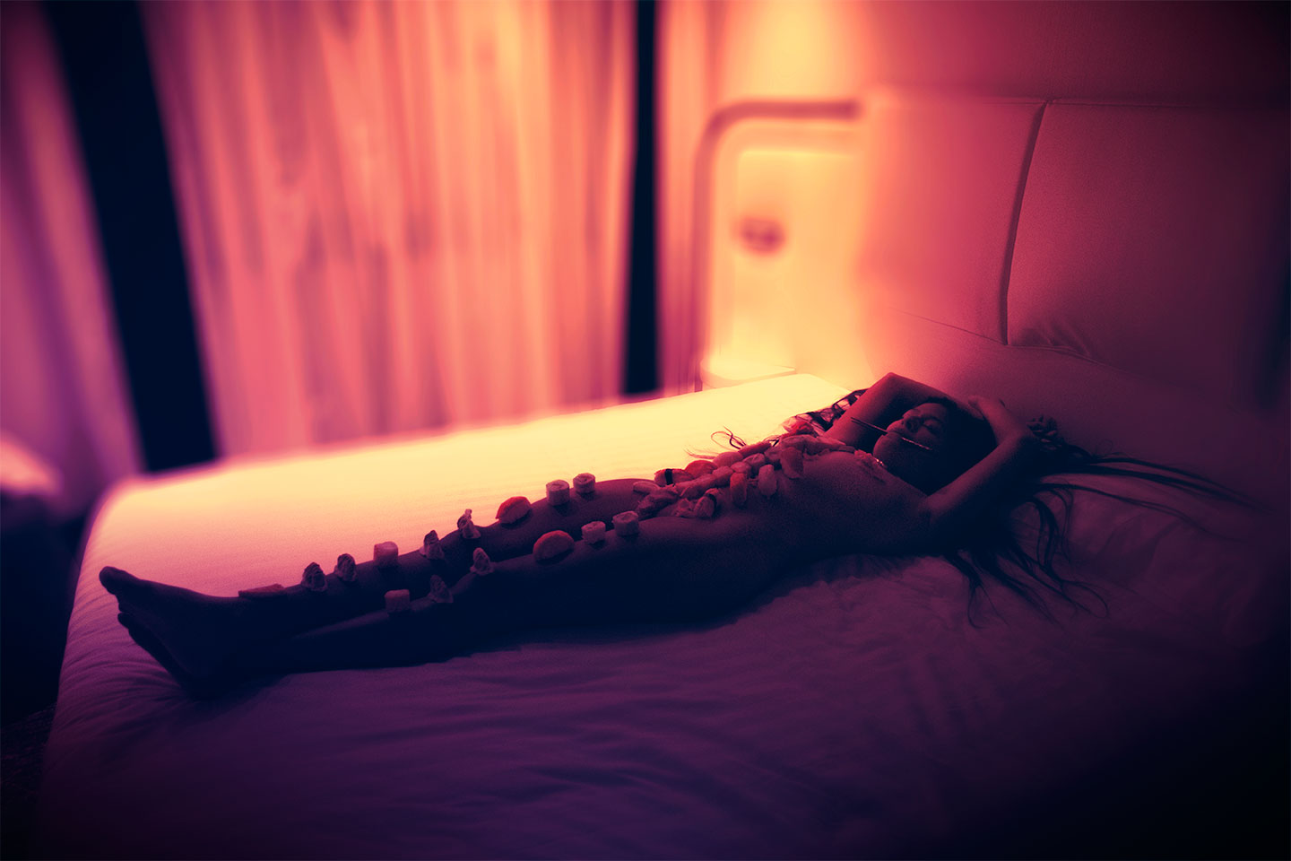 Nyotaimori or naked japanese model with sushi on body