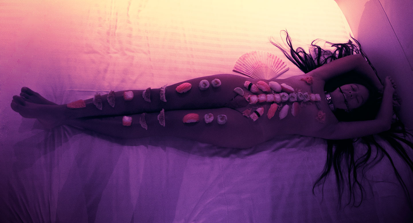 Nyotaimori or naked japanese model with sushi on body