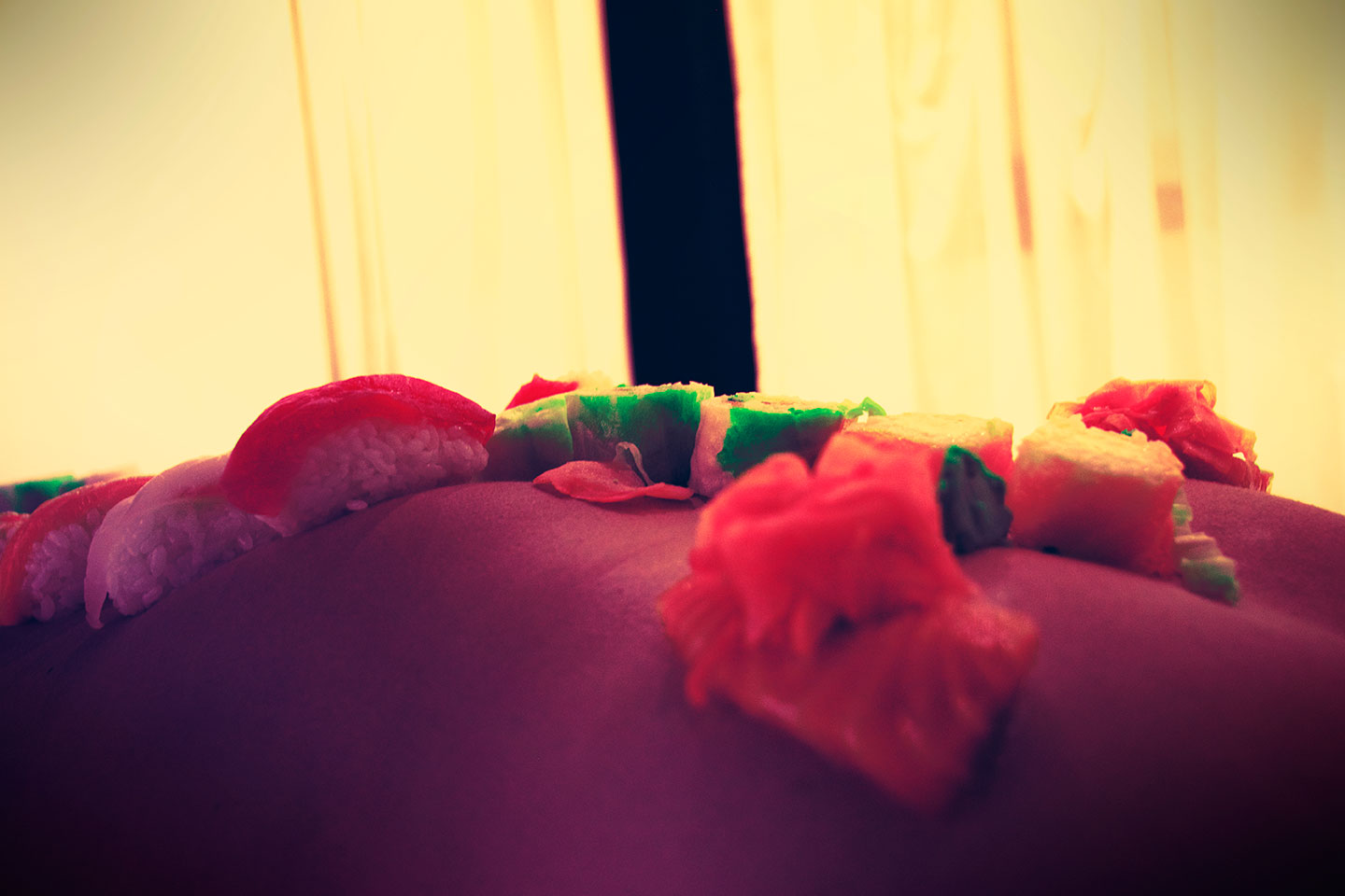 Nyotaimori or naked japanese model with sushi on body