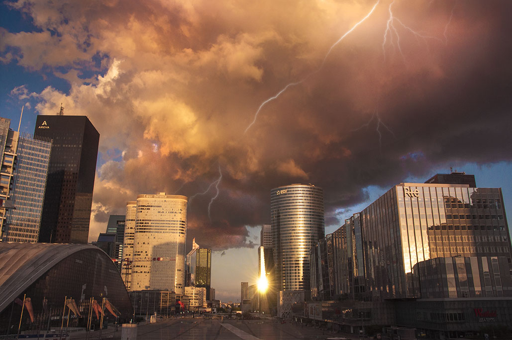 Paris La Défense under stormy big cloud lit by sunset and lightnings, (Nos Dren).