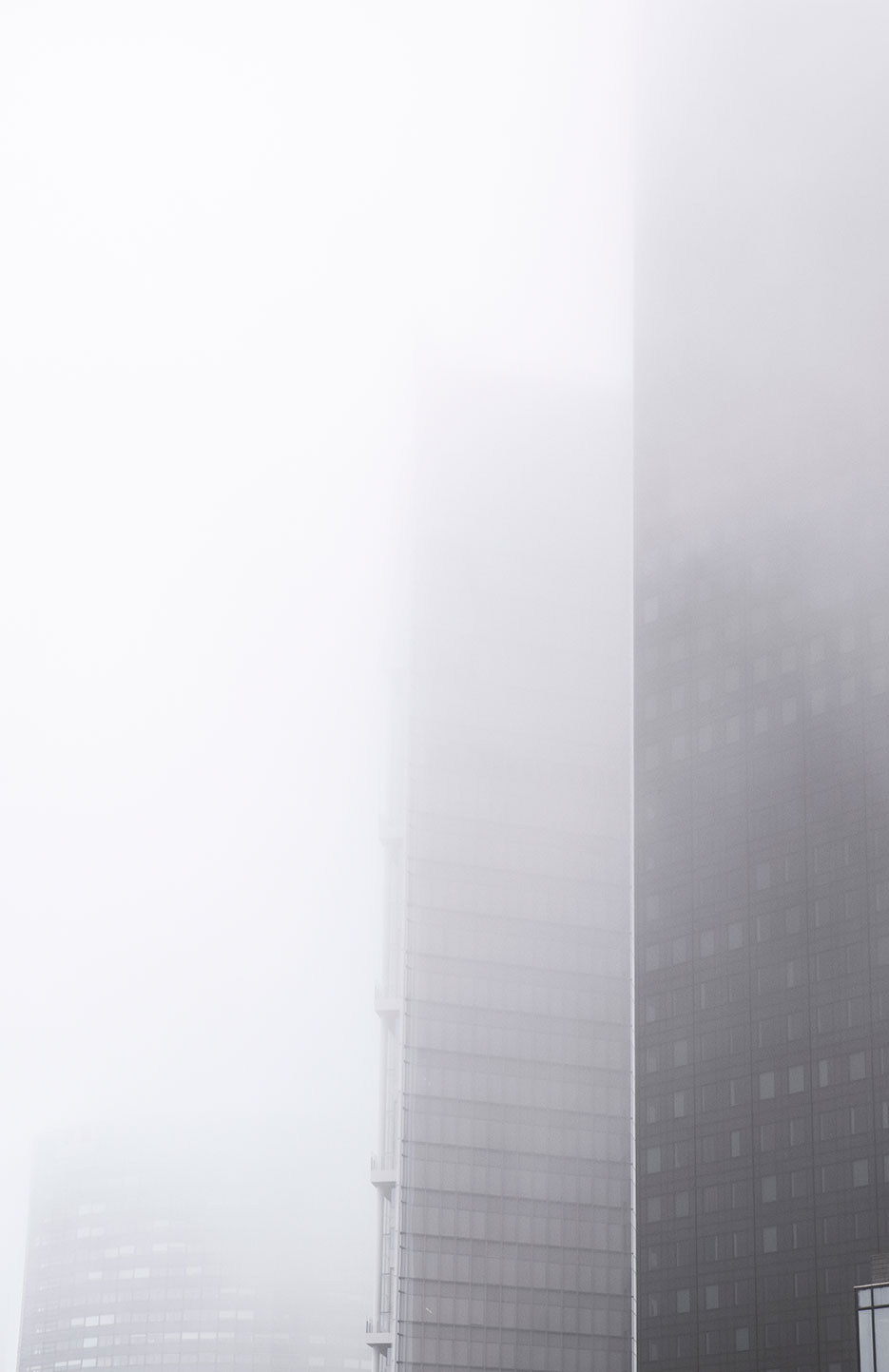 Mist and fog through the skyscrapers of Paris La Defense, France. (Nos Dren)
