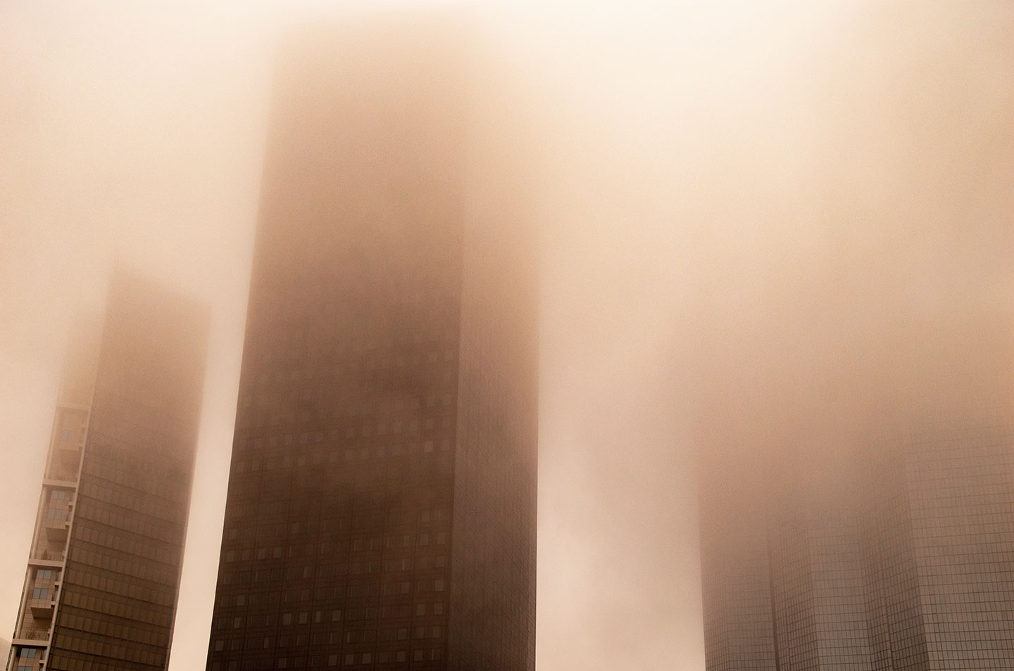 Mist and fog through the skyscrapers of Paris La Defense, France. (Nos Dren)