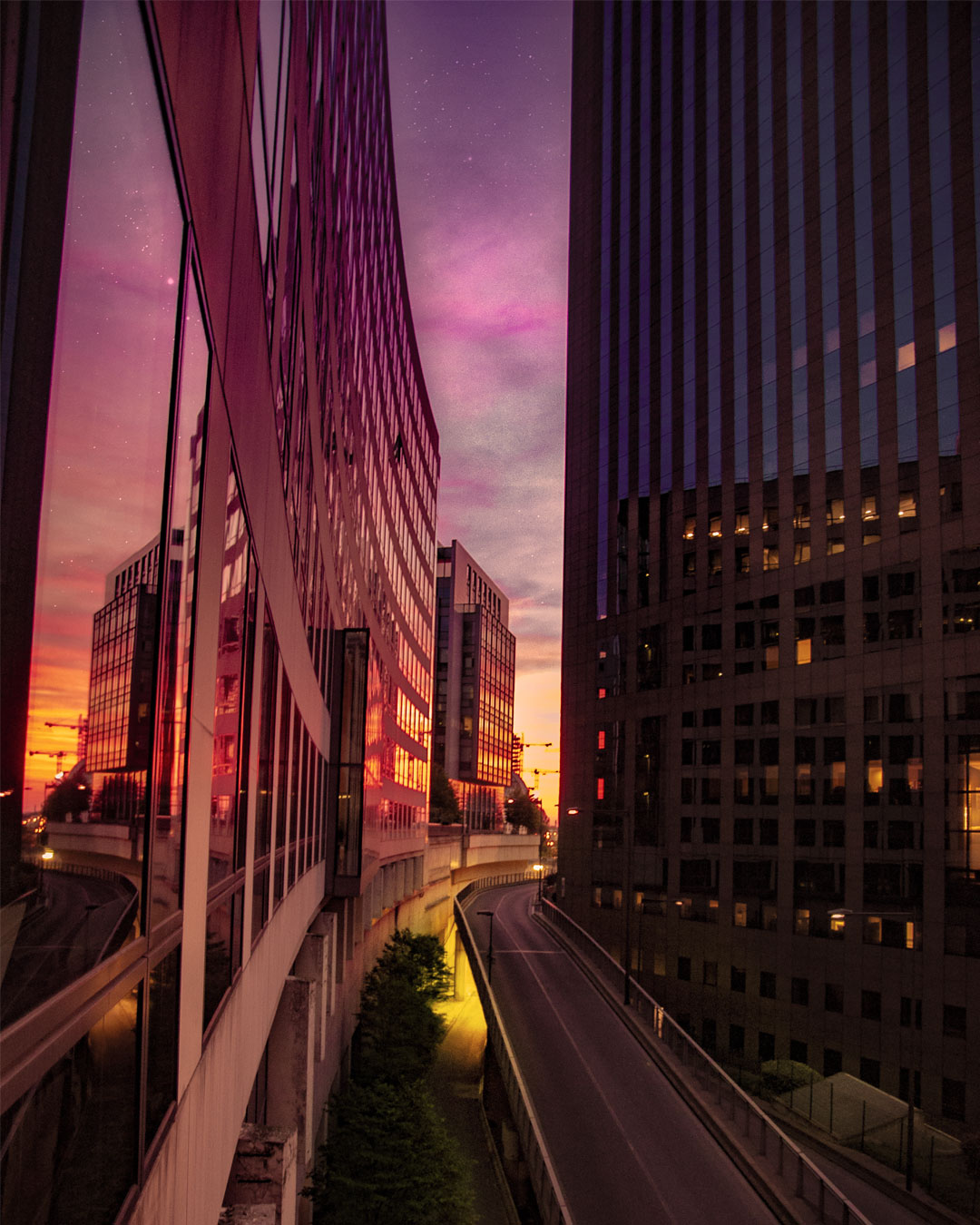 Colorful sunset sky in Paris La Défense, France, with mirror reflection. (Nos Dren)