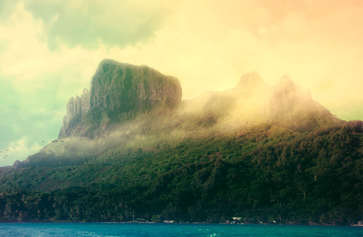 French Polynesia, Bora Bora island, mount Otemanu from aside with clouds, mist and dramatic light. (Nos Dren)